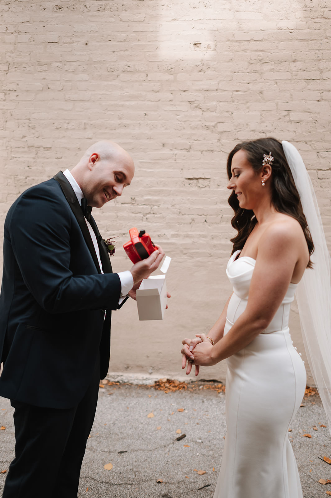 a bride and groom exchanging gifts on their wedding day